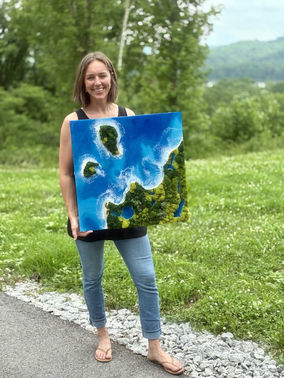 Anne Raisor holding a finished lake piece outdoors